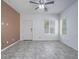 Inviting living room with neutral tile flooring, complemented by a ceiling fan and well-lit ambiance at 7753 Petite Pillar Ct, Las Vegas, NV 89149
