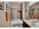 Bathroom with a shower over tub combo and dark vanity at 805 Palmero Way, Boulder City, NV 89005