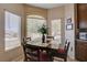 Inviting breakfast nook features bright light from outdoor views and a dark wood table at 805 Palmero Way, Boulder City, NV 89005