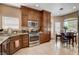 Well-appointed kitchen featuring stainless steel appliances, tile floors, and a cozy breakfast nook at 805 Palmero Way, Boulder City, NV 89005