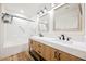 Modern bathroom featuring double sinks, quartz counters and a shower and tub combo at 831 E Valiant Ave, Pahrump, NV 89060