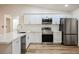 Modern kitchen featuring white cabinets, stainless steel appliances, and quartz countertops at 831 E Valiant Ave, Pahrump, NV 89060
