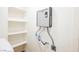 Features a wall-mounted Rheem water heater and white storage shelves for optimal efficiency and organized space utilization at 831 E Valiant Ave, Pahrump, NV 89060