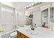 Bright bathroom with a tub and shower, white tile, and ample counter space at 8505 Lansdale Rd, Las Vegas, NV 89123