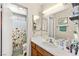 Bright bathroom with a well-lit vanity, mirror, updated sink, and shower at 8505 Lansdale Rd, Las Vegas, NV 89123