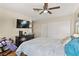 Comfortable bedroom with a ceiling fan, wall-mounted TV, and closet for storage at 8505 Lansdale Rd, Las Vegas, NV 89123