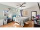 Spacious bedroom featuring a ceiling fan, hardwood floors, and bright natural light at 8505 Lansdale Rd, Las Vegas, NV 89123