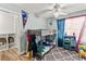 A bedroom with a modern ceiling fan, bunk bed, and built-in storage shelves at 8505 Lansdale Rd, Las Vegas, NV 89123