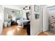 Bright bedroom with a large bed, wood floors, ceiling fan, and ensuite bathroom at 8505 Lansdale Rd, Las Vegas, NV 89123