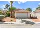 Charming single-story home featuring desert landscaping, a tile roof, and an attached two-car garage at 8505 Lansdale Rd, Las Vegas, NV 89123