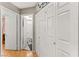 Hallway with wood floors, white doors and access to a bathroom at 8505 Lansdale Rd, Las Vegas, NV 89123