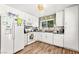 Well-lit kitchen with white appliances, tile backsplash, and modern cabinets at 8505 Lansdale Rd, Las Vegas, NV 89123