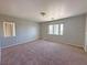 Spacious bedroom with neutral walls and plush carpeting; window provides natural light at 9034 Grenache St, Las Vegas, NV 89148
