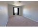 Bright bedroom with plush carpeting and a window letting in natural light at 9034 Grenache St, Las Vegas, NV 89148