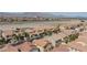 An aerial view of a residential neighborhood with similar single-Gathering homes and desert landscaping against a mountain backdrop at 9039 Alex Creek Ave, Las Vegas, NV 89149