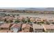 Aerial view of neighborhood showing tile roofs and freeway in the distance at 9039 Alex Creek Ave, Las Vegas, NV 89149