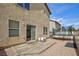 Backyard with wood deck, gravel area, trampoline and tan stucco home exterior at 9039 Alex Creek Ave, Las Vegas, NV 89149