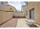 Backyard featuring a wood deck, gravel area, pink scooters, and stucco walls at 9039 Alex Creek Ave, Las Vegas, NV 89149