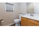 Cozy powder room with a white vanity and a small window for natural light at 9039 Alex Creek Ave, Las Vegas, NV 89149