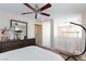 Loft bedroom features a dark dresser, a ceiling fan, and natural light from a window at 9039 Alex Creek Ave, Las Vegas, NV 89149