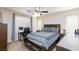 Bedroom with desk, ceiling fan, and plush bedding, providing a comfortable and functional space at 9039 Alex Creek Ave, Las Vegas, NV 89149