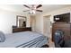 Bedroom with ceiling fan, television, and spacious layout, providing a comfortable and open living space at 9039 Alex Creek Ave, Las Vegas, NV 89149