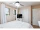Bright bedroom with a chandelier and white bedding, featuring a window letting in natural light at 9039 Alex Creek Ave, Las Vegas, NV 89149