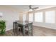 Bright dining area featuring a modern table and wood-look tile flooring at 9039 Alex Creek Ave, Las Vegas, NV 89149