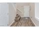 Bright entryway with hardwood floors, staircase, and white door creating a welcoming space at 9039 Alex Creek Ave, Las Vegas, NV 89149