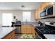 Close up of a kitchen featuring granite countertops and stainless steel appliances at 9039 Alex Creek Ave, Las Vegas, NV 89149