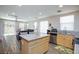 Open kitchen flowing to living area with stainless appliances and granite countertops at 9039 Alex Creek Ave, Las Vegas, NV 89149