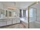 Spacious bathroom featuring a double sink vanity, shower, and soaking tub with natural light at 9348 Buckhaven Dr, Las Vegas, NV 89117