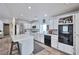 Bright kitchen features white cabinets, tile countertops, and modern appliances at 9348 Buckhaven Dr, Las Vegas, NV 89117