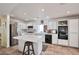Bright kitchen features white cabinets, tile countertops, and modern appliances at 9348 Buckhaven Dr, Las Vegas, NV 89117