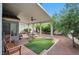 Covered patio with ceiling fan, seating, and well-maintained landscaping at 9348 Buckhaven Dr, Las Vegas, NV 89117