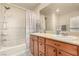 Bathroom featuring double sinks and a shower-tub combination at 9690 Langden Brook St, Las Vegas, NV 89178