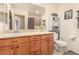 Bright bathroom featuring a double vanity, framed mirror, and toilet, providing a practical layout at 9690 Langden Brook St, Las Vegas, NV 89178