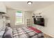 Bedroom with a street sign decoration, shelves, and a TV, offering a personalized touch at 9690 Langden Brook St, Las Vegas, NV 89178