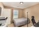 Bedroom with neutral walls and carpet, a window with blinds, and a desk, creating a simple and functional space at 9690 Langden Brook St, Las Vegas, NV 89178