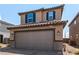 Attractive home features a brick driveway, well-maintained landscaping, and a two-car garage, creating a welcoming entrance at 9690 Langden Brook St, Las Vegas, NV 89178