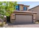 Charming house with an attached garage, brick driveway, and blue shutters adds charm to its front yard at 9690 Langden Brook St, Las Vegas, NV 89178