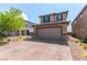 Charming home features a brick driveway, manicured landscaping, and a two-car garage, enhancing its curb appeal at 9690 Langden Brook St, Las Vegas, NV 89178