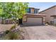 Well-maintained home with a two-car garage and brick driveway, complemented by neat landscaping and charming curb appeal at 9690 Langden Brook St, Las Vegas, NV 89178