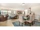 Open-concept living area with modern kitchen, dining area, and plush seating at 9690 Langden Brook St, Las Vegas, NV 89178
