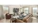 Sunlit living room boasts comfortable seating, large windows with a view of the pool, and stylish decor at 9690 Langden Brook St, Las Vegas, NV 89178