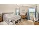Bright main bedroom with a king bed and a view of the backyard at 9690 Langden Brook St, Las Vegas, NV 89178
