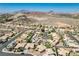 A high angle shot overlooking a well-planned community nestled in a desert valley with mountain views at 983 Cutter St, Henderson, NV 89011