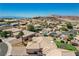 Aerial view of the home and neighborhood showcasing desert landscaping, a tile roof, and mature trees at 983 Cutter St, Henderson, NV 89011