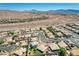 Wide aerial shot of desert homes with pools near highway and desert landscape with mountains in background on clear day at 983 Cutter St, Henderson, NV 89011