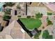 An aerial shot reveals a tidy backyard with artificial turf, a fire pit, and minimal desert landscaping at 983 Cutter St, Henderson, NV 89011